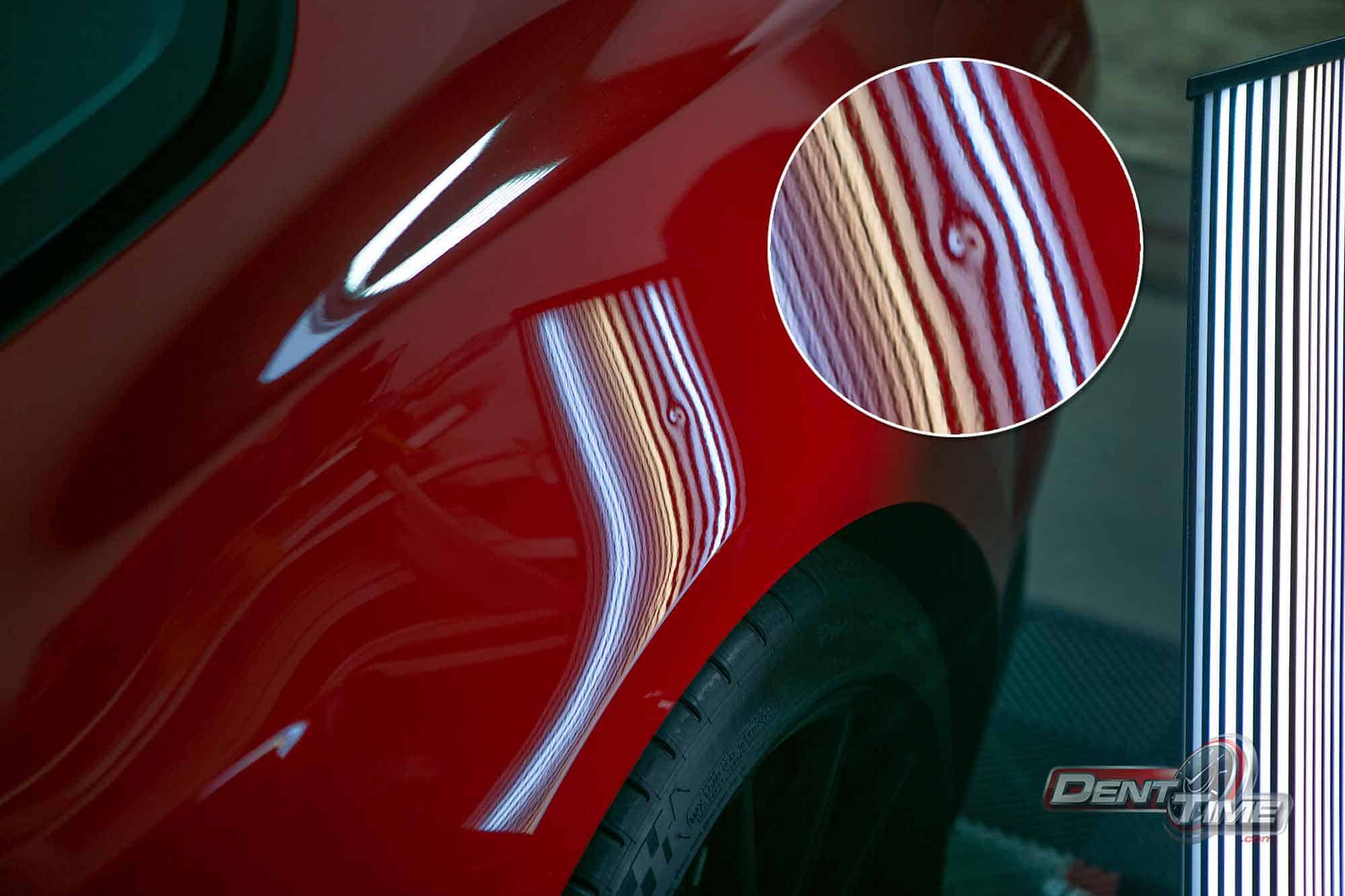 Ford Mustang door panel under raking light after door ding repair
