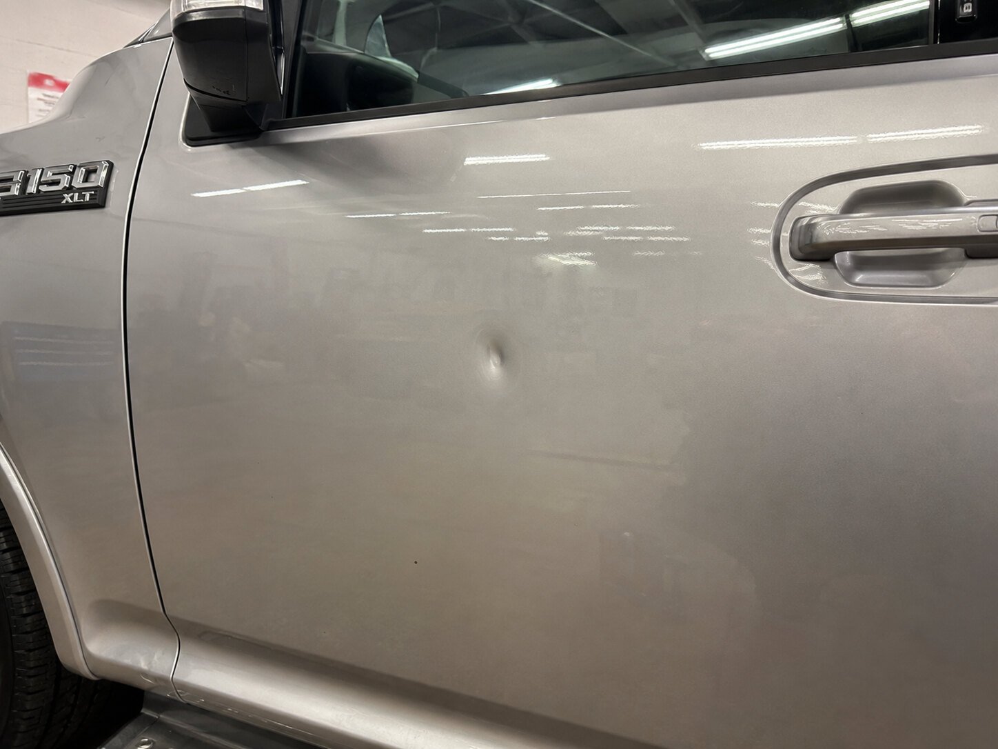 Ford F-150 aluminum door before, deep stretched dent