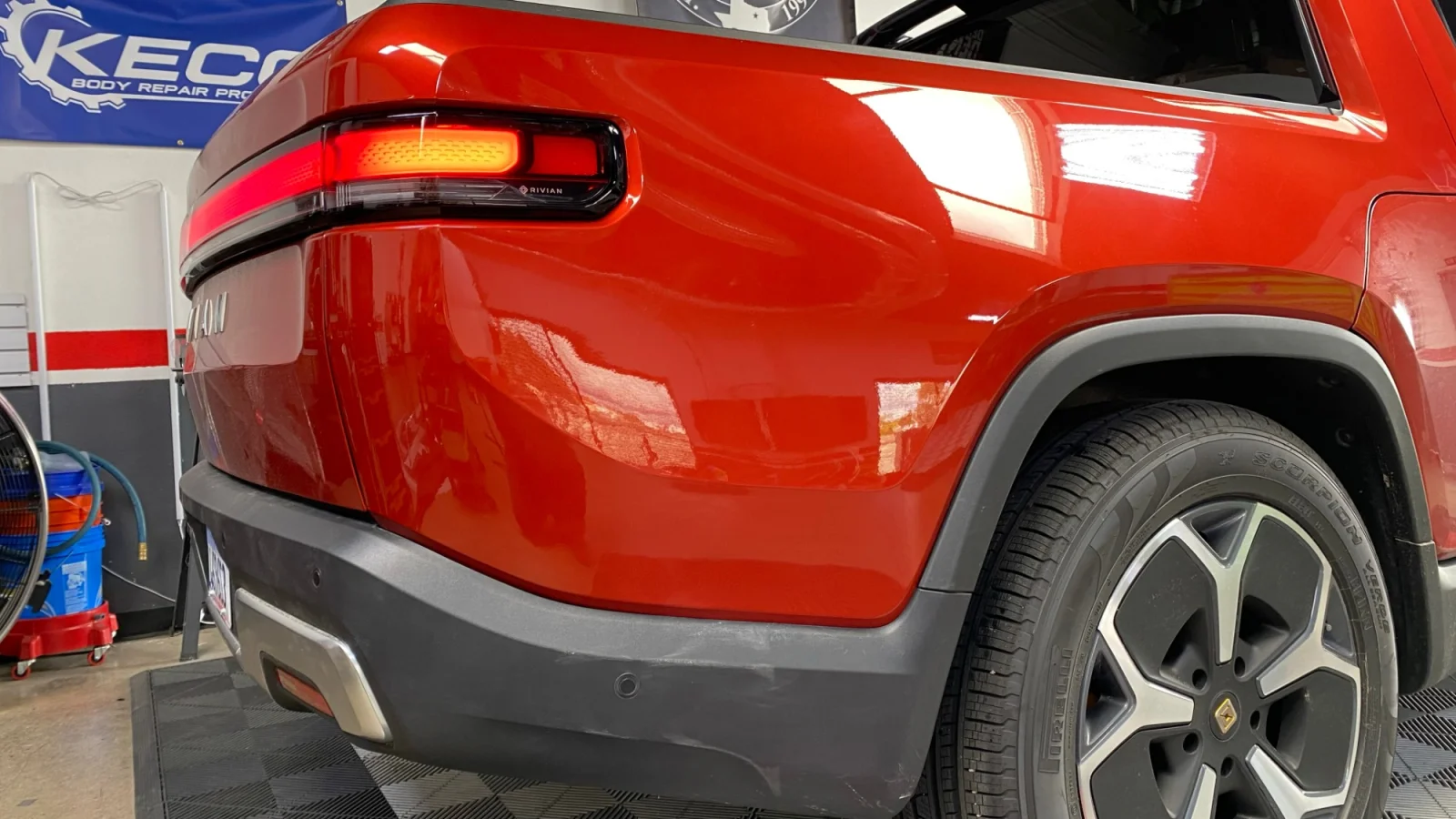 A large rear quarter-panel dent before paintless dent repair