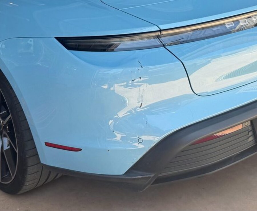 Gouge and scrape running down the rear quarter of a Porsche Taycan before mobile refinish in San Diego