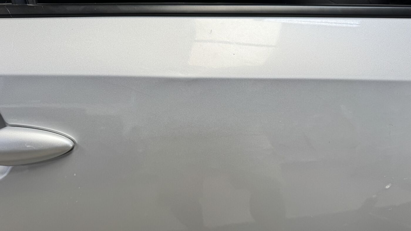Silver door panel after a Practical standard paintless dent repair